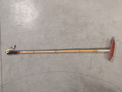 a long stick with a handle on the floor