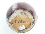 a close up of a vase with a label on it