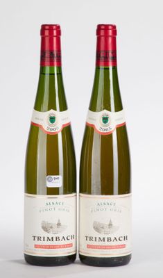 two bottles of wine sitting next to each other on a white surface