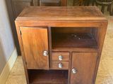 a wooden cabinet with two drawers and a door