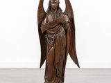 an image of a wooden statue of an angel holding a baby