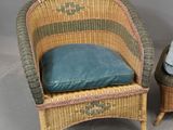 pair of wicker chairs with blue cushions and a small table