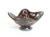 bowl shaped like a flower with holes in the center