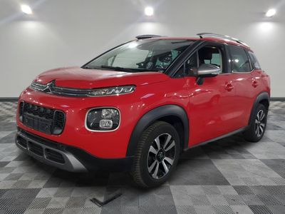 a red citrole is parked on a checkered tile floor
