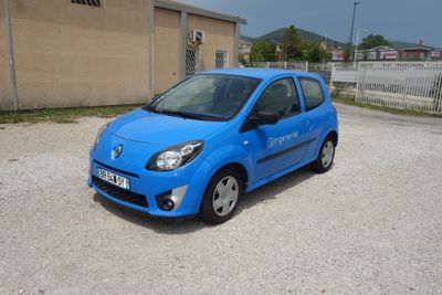 a small blue car parked in a parking lot