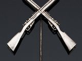 two guns are on a black surface with a black background
