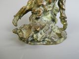 a bronze statue of a man and a dog on a rock