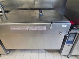 a large stainless steel oven sitting in the middle of a kitchen