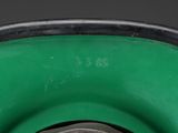 a close up view of a green vase with a black rim