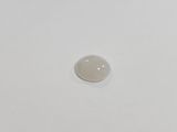 an oval white stone sitting on top of a white surface