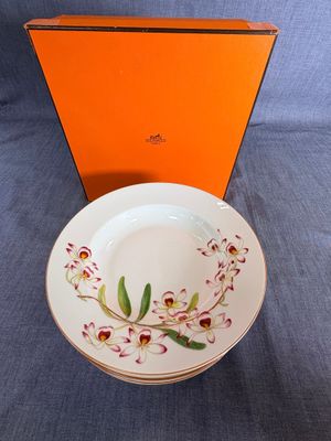 une boîte orange ornée d'une assiette blanche et d'une fleur rouge