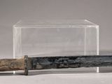 an old knife with a wooden handle in a clear box