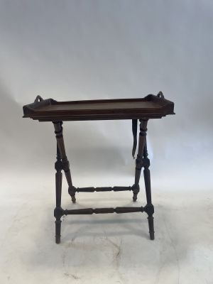 a small wooden table with a tray on top of it