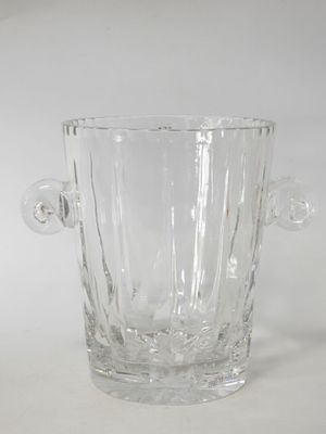 a clear glass vase with a handle on a table