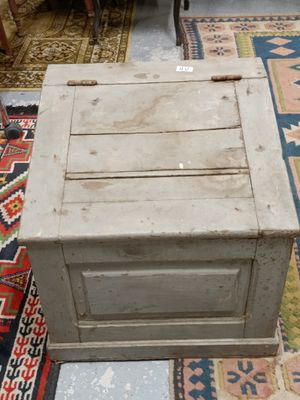 an old wooden chest sitting on a rug in a living room
