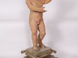 an image of a statue of a child on a pedestal