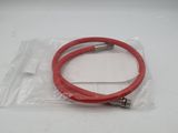 a close up of a red hose on a white surface
