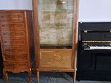 a piano and a cabinet in the corner of a room