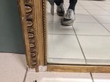 a reflection of a person walking in front of a mirror