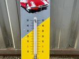 a thermometer with a picture of a red car on it