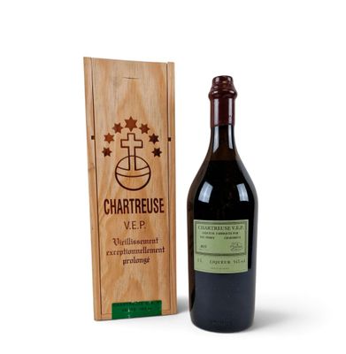the bottle of wine is next to a wooden box