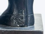 a statue of a boot that is sitting on top of a box