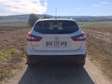 a white car that is parked on the side of the road