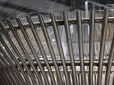 a close up of a metal chair with a lot of nails on it