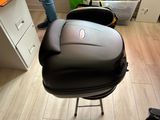 a black suitcase sitting on a stool in a kitchen