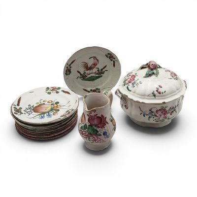 many plates, cups, and saucers sitting on a table
