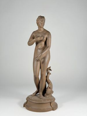 an image of a bronze statue of a woman holding a dog