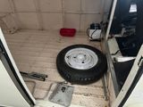 a tire that is sitting in the back of a van