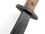 a close up of a knife on a white surface