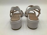 a pair of white sandals on a white surface with a white background