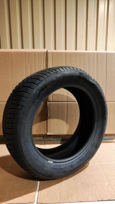 tire on the floor next to cardboard boxes in a room