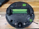 a black and green robot that is on a wooden table