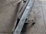 several pieces of metal are laying on the floor in a warehouse