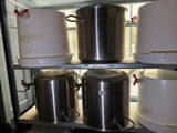 several pots and pans are stacked on a shelf in a refrigerator