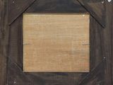 an old wooden picture frame with a picture hanging on a wall