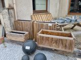 a lot of wooden boxes that are outside on the ground