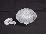 an image of a glass bowl and a spoon on a black background