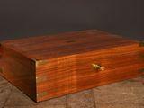 an old wooden box sitting on top of a tiled floor