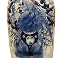 a blue and white vase with a bird on it