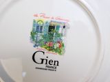 a white plate with a picture of a house on it