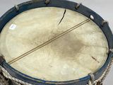 a drum that is sitting on a white surface