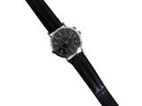 a close up of a watch on a white background with a black strap