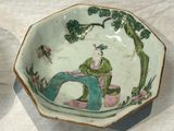 a bowl that has a man sitting on a tree