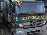 two trucks that are parked in front of a building