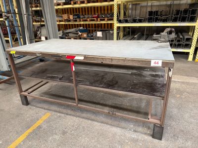 a table that is sitting in the middle of a warehouse