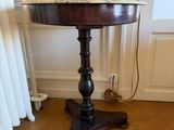 a table with a vase on top of it in a room